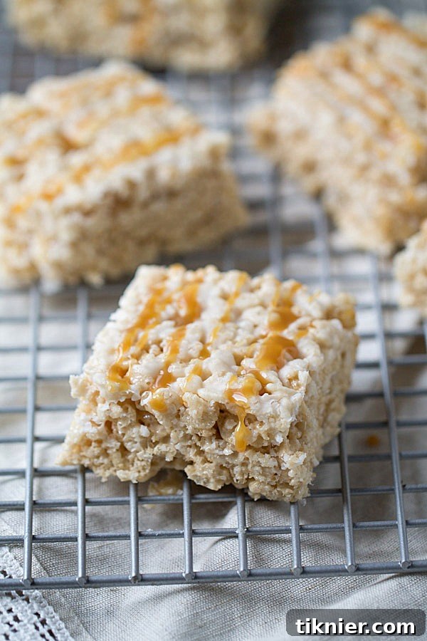 Stacked Caramel Macchiato Krispie Treats on a plate, highlighting the rich caramel.