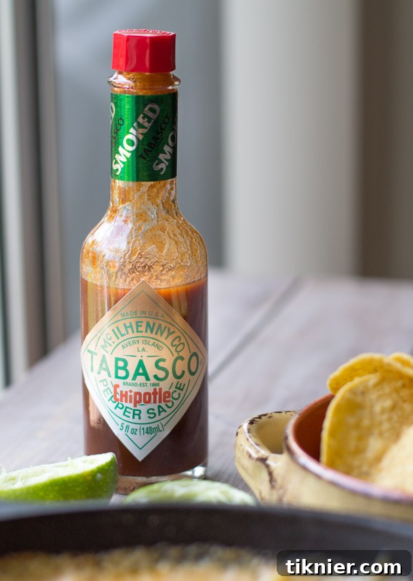 Delicious Cheesy Chipotle Shrimp and Corn Dip topped with fresh chives, ready to serve