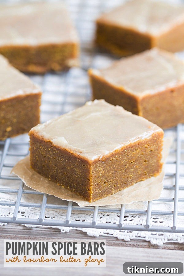 The BEST fudgy Pumpkin Spice Bars with Bourbon Butter Glaze. These melt in your mouth bars will make you swoon! A perfect fall dessert.
