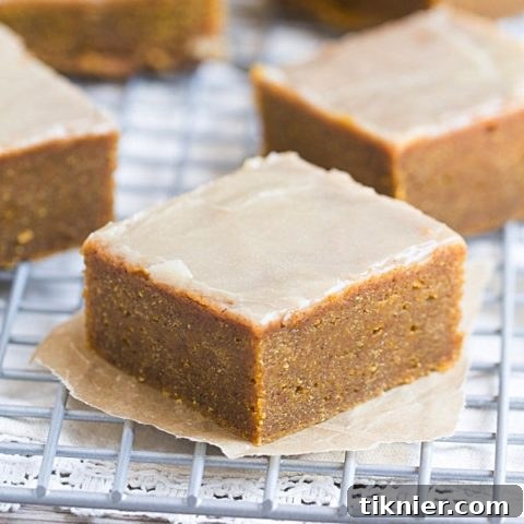 Beautifully presented Pumpkin Spice Bars with Bourbon Butter Glaze, showcasing their vibrant fall colors.