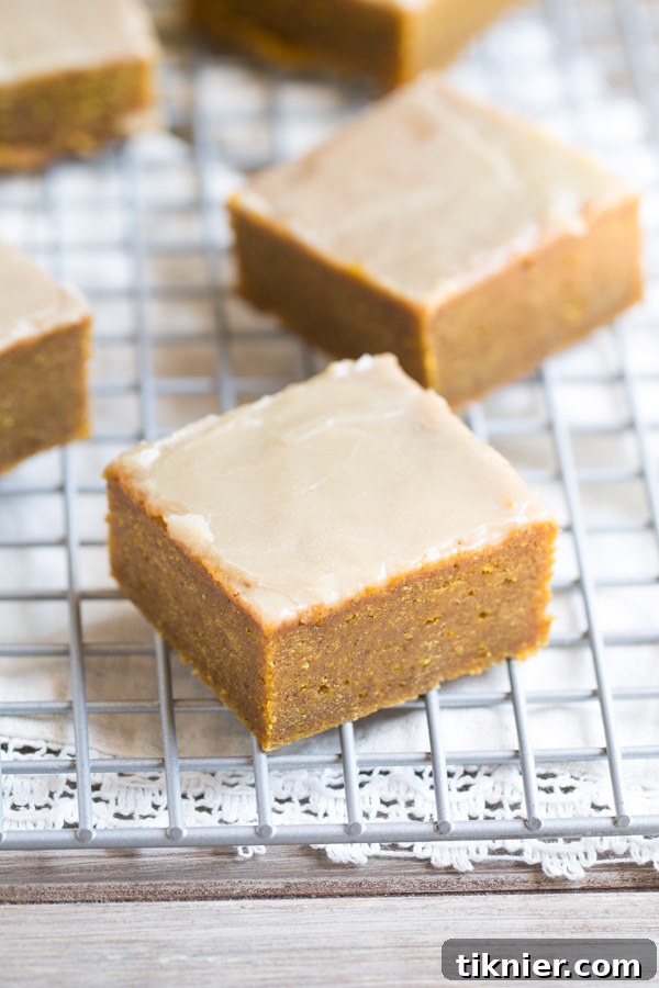 A full tray of Pumpkin Spice Bars generously covered with a rich Bourbon Butter Glaze, showcasing a perfect batch.