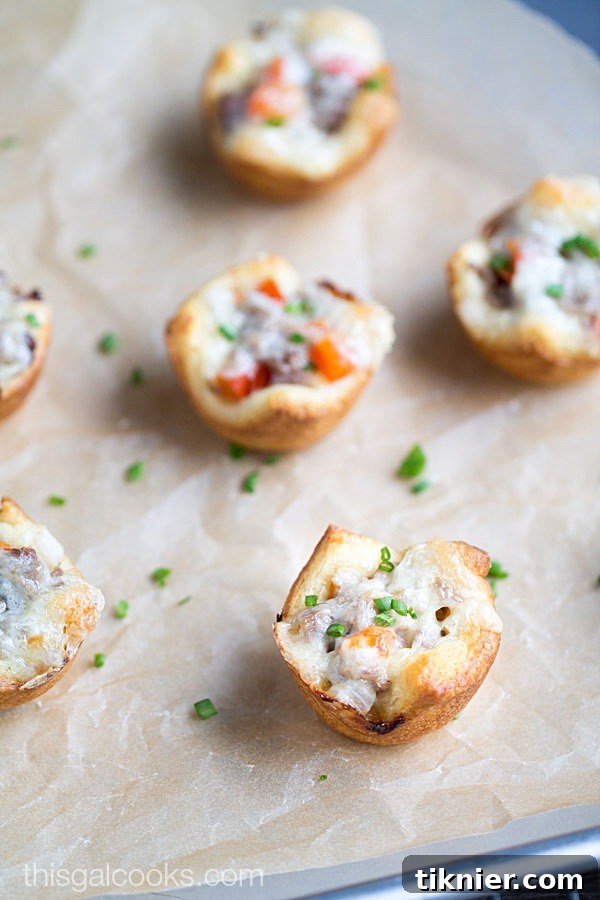 Perfectly baked Cheesesteak Crescent Roll Cups displayed from a slightly elevated angle, highlighting their appetizing appearance.