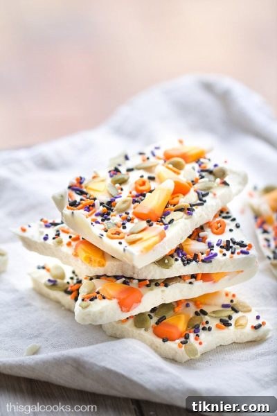 Colorful Candy Corn White Chocolate Halloween Bark, an easy and festive dessert from This Gal Cooks, perfect for trick-or-treaters. #candy corn #halloween #whitechocolate #bark