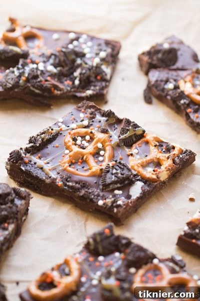 Amazing Dark Chocolate Oreo Pretzel Bark recipe from This Gal Cooks, a perfect blend of sweet, salty, and crunchy for any occasion. #dessert #candybark #chocolate #oreo #pretzels