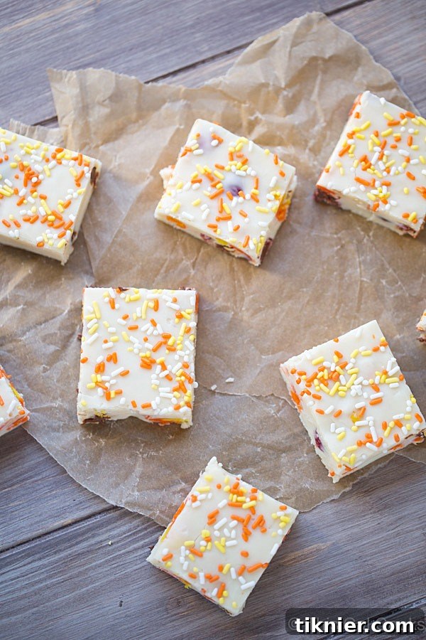 Close-up of a generous slice of Candy Corn M&M White Chocolate Fudge showcasing its colorful mix-ins.