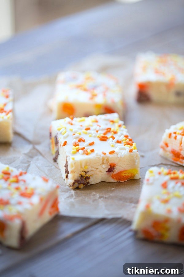 A selection of colorful Candy Corn M&M White Chocolate Fudge squares, perfectly cut and ready to serve.