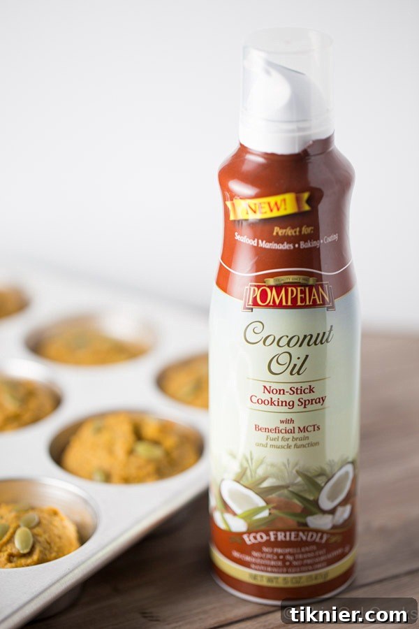 Close-up of healthier pumpkin muffins, showcasing their golden-brown tops and moist texture. Made with coconut oil, honey, and whole wheat flour for a healthier twist.