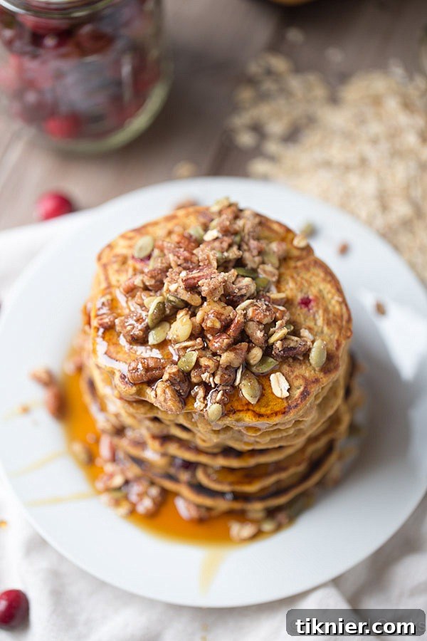 Close-up of fluffy Cranberry Pumpkin Pancakes on a plate.