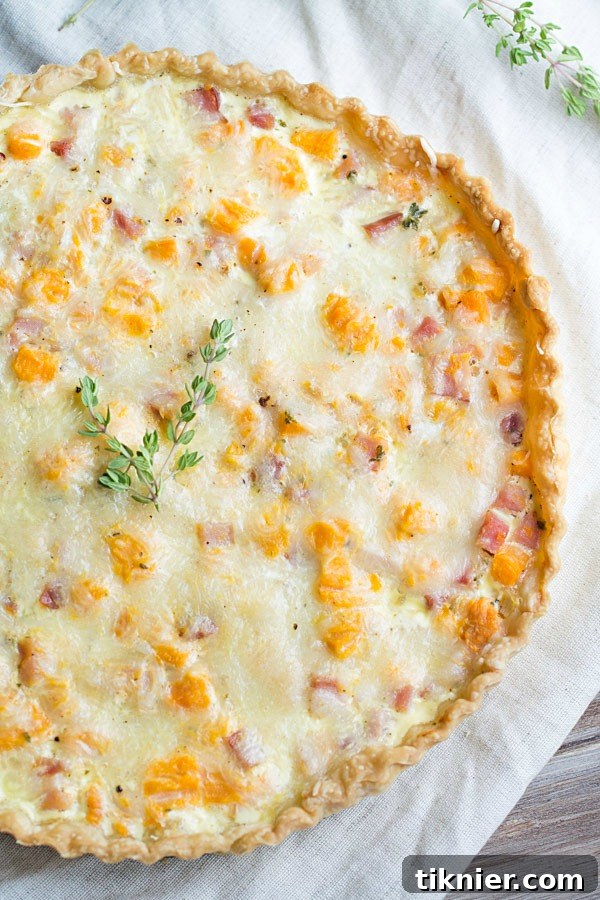 Savory Sweet Potato, Ham and Swiss Tart with a golden crust, perfect for a festive brunch. | This Gal Cooks