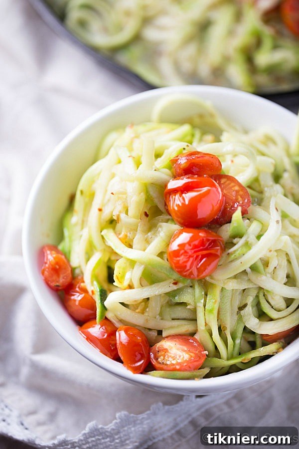 Simple and healthy zucchini noodles tossed with roasted tomatoes and a light white wine sauce, cooked in one skillet.