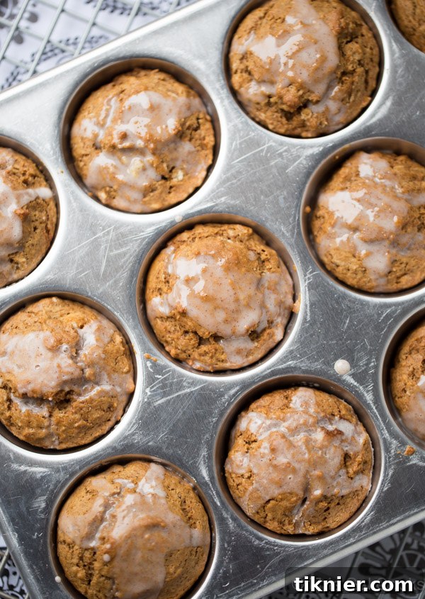 Stacked gingerbread muffins with glaze, showcasing their appeal.