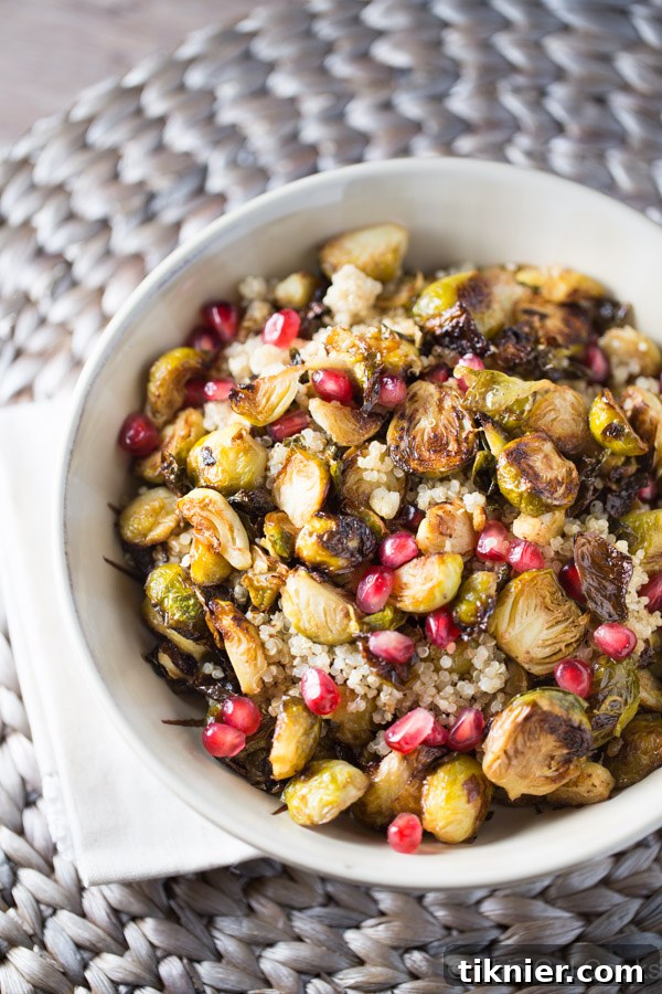 A beautifully presented bowl of Roasted Brussels Sprouts with Quinoa and Pomegranate, highlighting the vibrant colors and healthy ingredients.