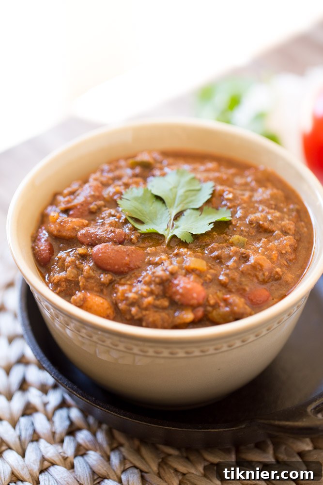 Rich and hearty beef chili, thick with masa harina, served in a bowl.
