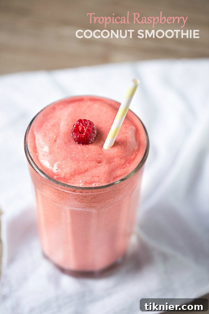 Delicious Tropical Raspberry Coconut Smoothie in a glass, ready to be enjoyed.