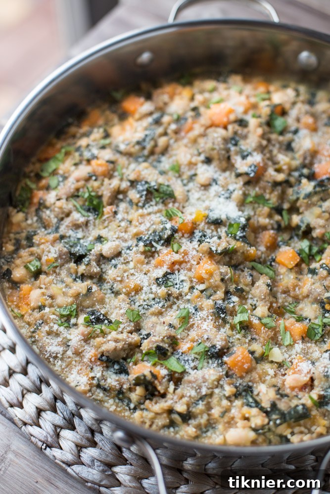 Large skillet of Skillet Farro and Turkey Sausage Casserole with fresh herbs
