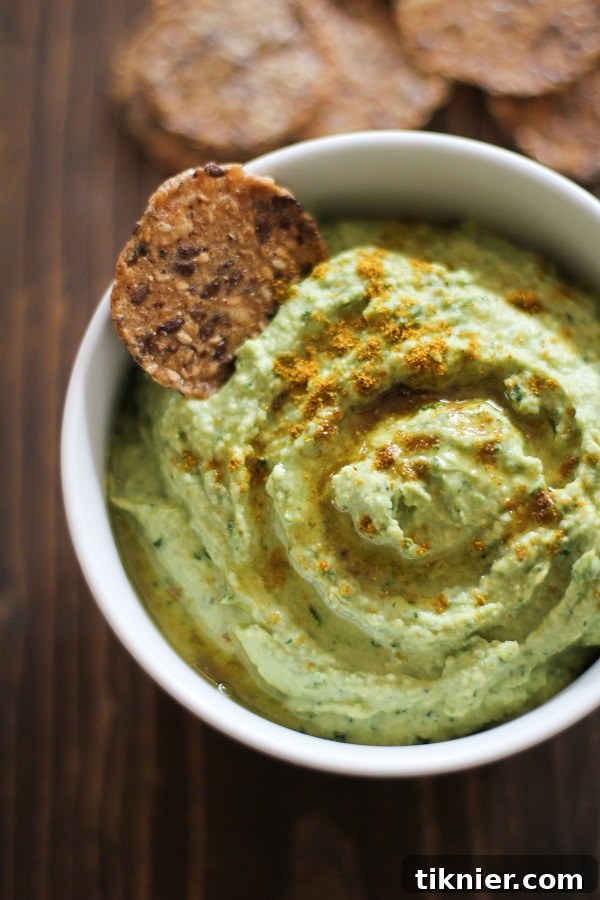Delicious and healthy Roasted Garlic Kale Hummus, a perfect vibrant green dip.