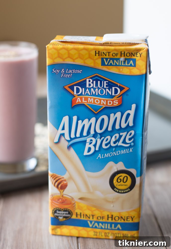 A vibrant Strawberry Banana Oatmeal Protein Smoothie in a clear glass, ready to be enjoyed. Highlighted ingredients for a thick, creamy, and filling drink. #smoothie #plantbased #breakfast #vegetarian #realfood #glutenfree