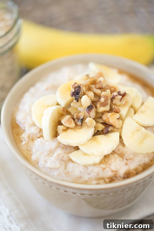Smooth, creamy, and slightly tangy Banana Oatmeal, sweetened with natural maple syrup and topped with crunchy walnuts for a healthy and hearty breakfast. Features Greek yogurt for a rich texture.