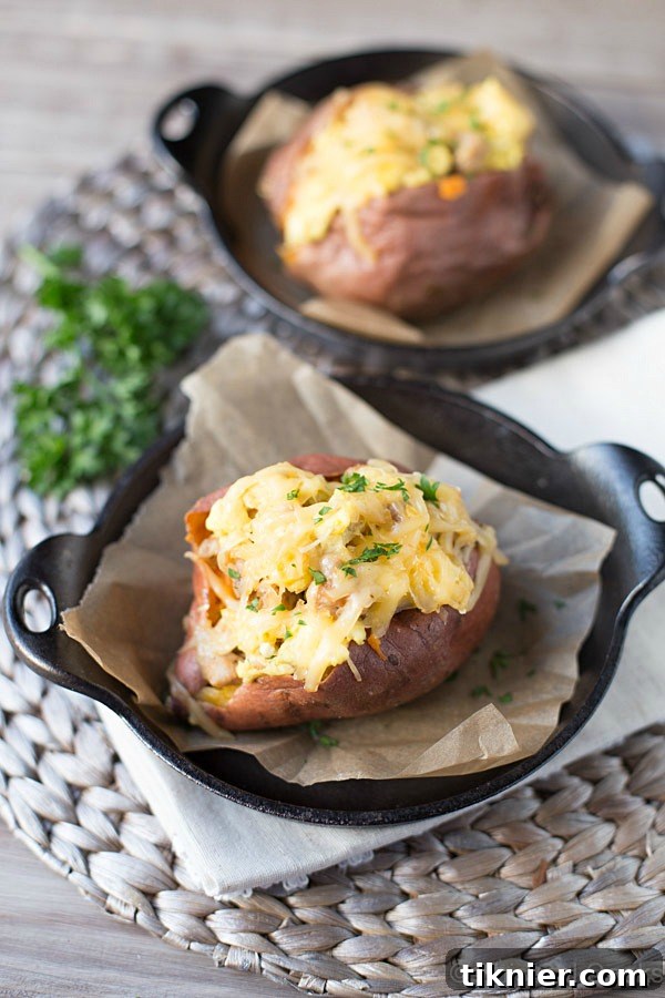 Hearty and healthy Breakfast Sweet Potatoes stuffed with eggs, chicken sausage, and smoked gouda cheese for a satisfying morning meal.