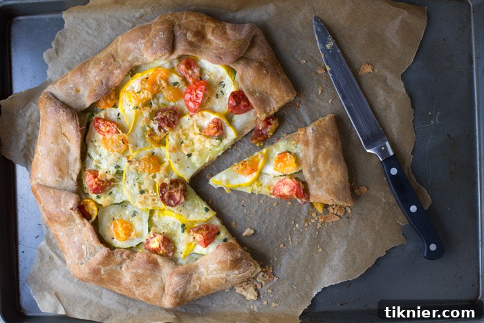 Close-up of Summer Squash Tart with Roasted Tomatoes, showing texture and golden crust