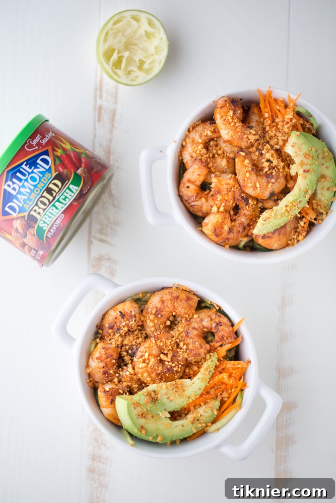 Closeup of a Spicy Shrimp Cucumber Noodle Bowl, showcasing fresh shrimp, cucumber noodles, and chopped Sriracha almonds.