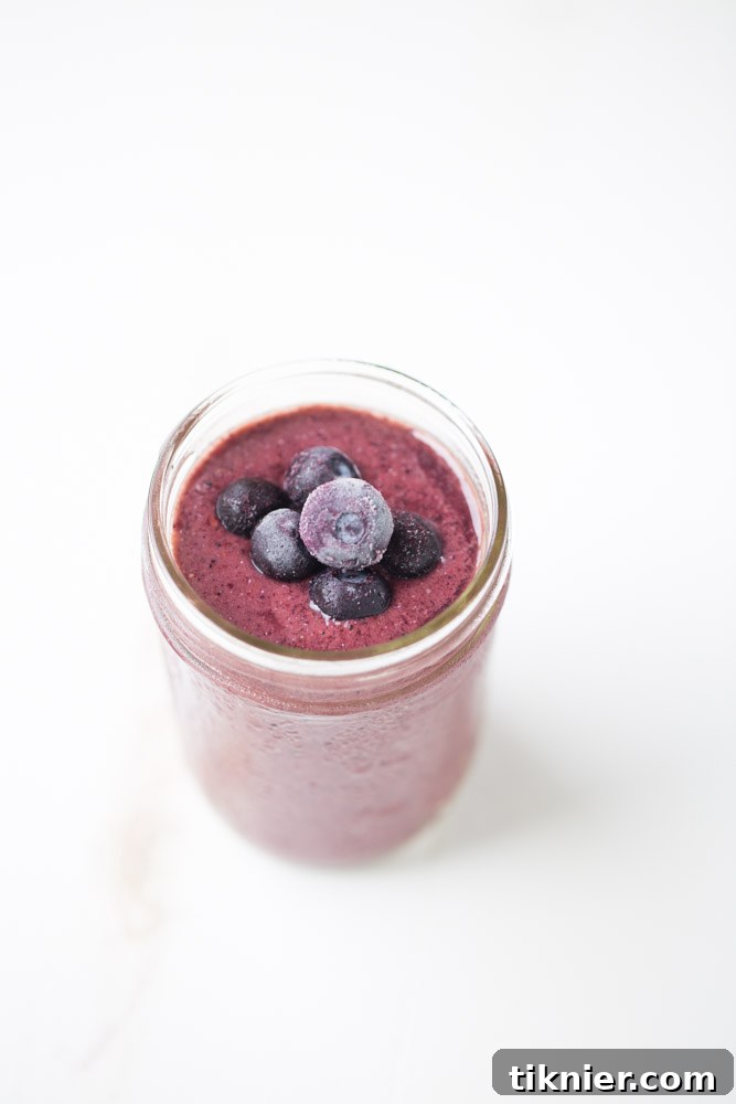 Berry Cherry Pineapple Smoothie in a glass, ready to be enjoyed