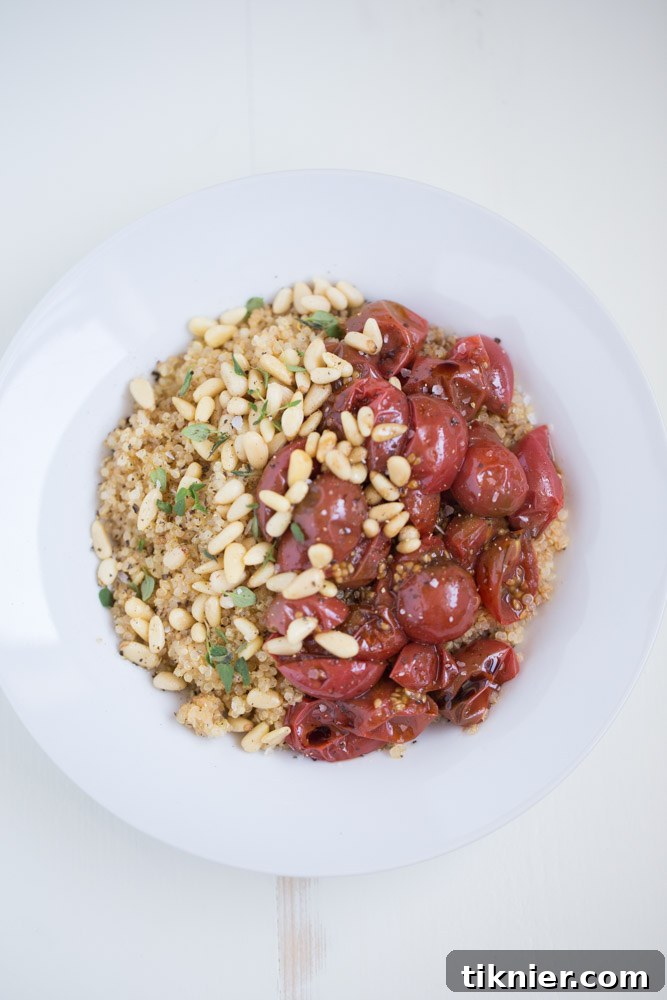 Effortless Vegan Roasted Tomato Quinoa Bowl 5 Artistically plated Quick Quinoa Bowl with roasted tomatoes, pine nuts and fresh thyme, showcasing a healthy and visually appealing vegan dish.