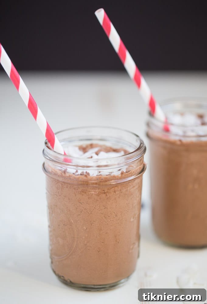 Overhead view of Coconut Mocha Coffee Smoothie ingredients laid out on a table, including coffee, coconut milk, banana, and Zing Stevia.