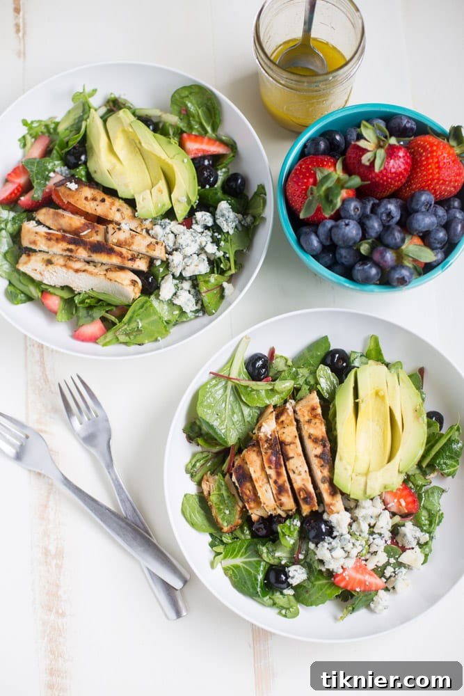 Gorgonzola Chicken Salad with Berries and Avocado is a fresh and healthy salad full of fresh fruit, gorgonzola, super greens and it's dressed with homemade honey balsamic vinaigrette!