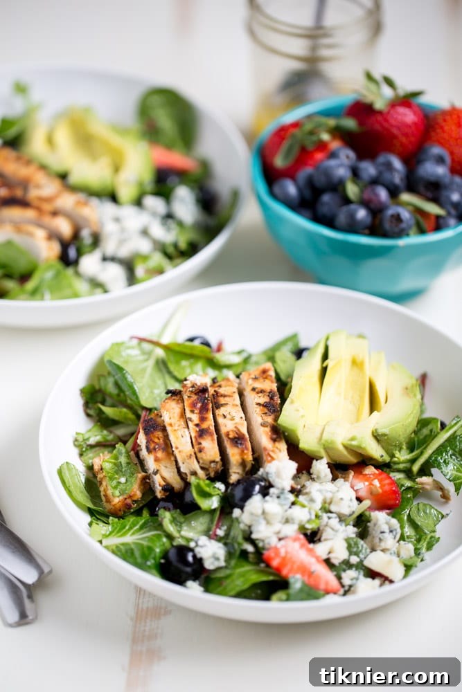 Gorgonzola Chicken Salad with Berries and Avocado is a fresh and healthy salad full of fresh fruit, gorgonzola, super greens and it's dressed with homemade honey balsamic vinaigrette!