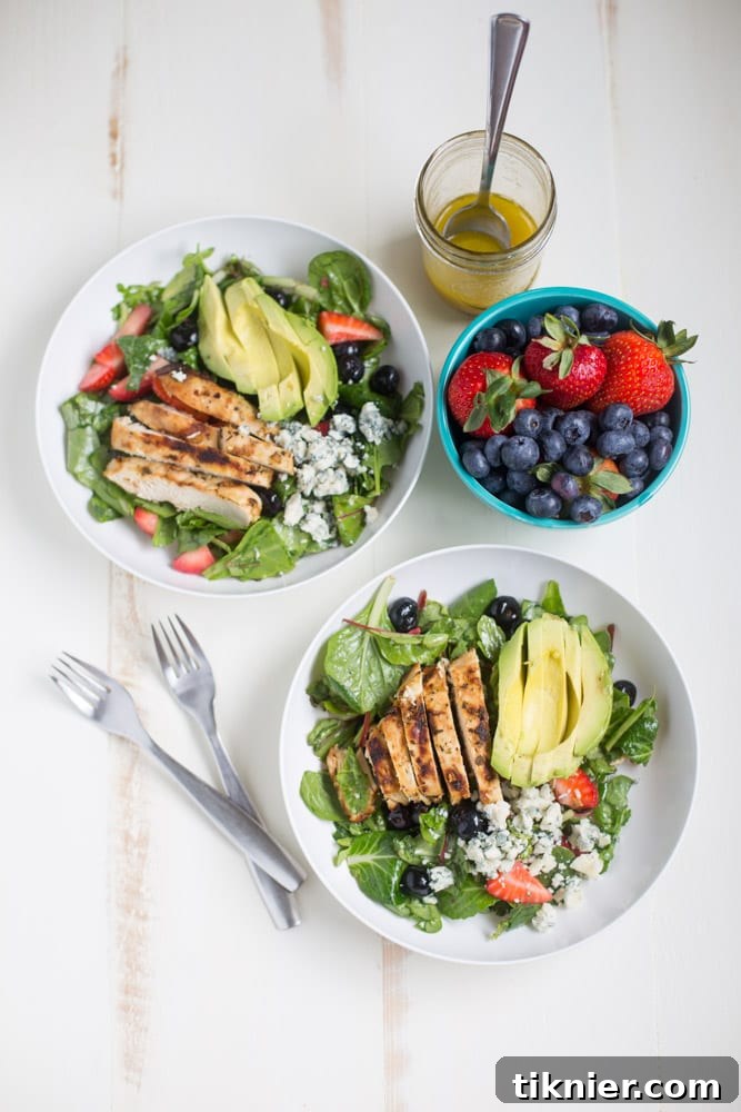 Gorgonzola Chicken Salad with Berries and Avocado is a fresh and healthy salad full of fresh fruit, gorgonzola, super greens and it's dressed with homemade honey balsamic vinaigrette!