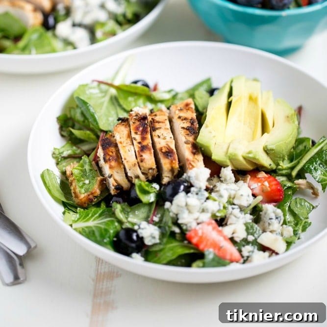 Gorgonzola Chicken Salad with Berries and Avocado is a fresh and healthy salad full of fresh fruit, gorgonzola, super greens and it's dressed with homemade honey balsamic vinaigrette!