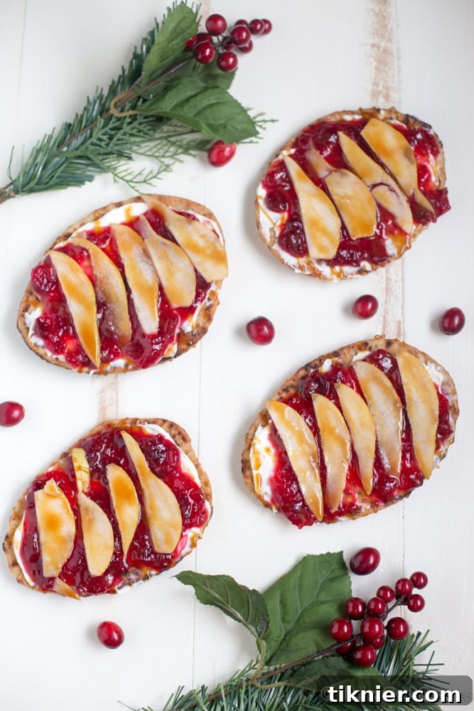 Beautifully arranged Cranberry Pear Flatbread on a cutting board, ready to serve.