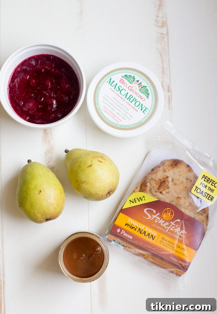 Close-up of Cranberry Pear Flatbread featuring creamy mascarpone, vibrant cranberry sauce, and thinly sliced pears.