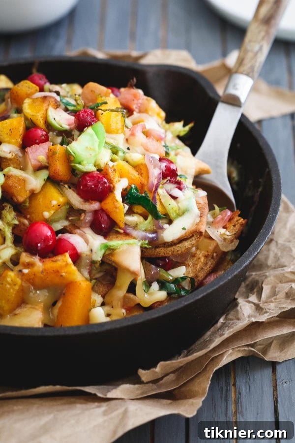 Colorful Butternut Squash Pita Nachos, generously topped with roasted squash, cranberries, and fresh ingredients.