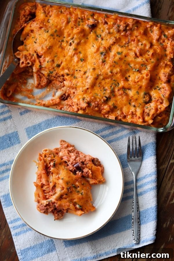 A large, inviting serving of gluten-free pasta casserole on a plate, showing the rich texture and topping.