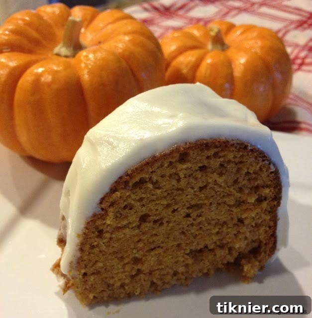 Delicious pumpkin spice bundt cake with homemade cream cheese frosting, a perfect fall treat.