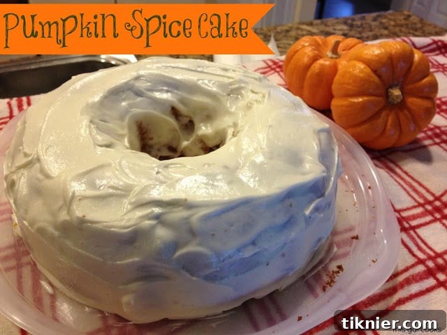 A beautifully decorated slice of easy pumpkin spice cake with cream cheese frosting, ready to be served.