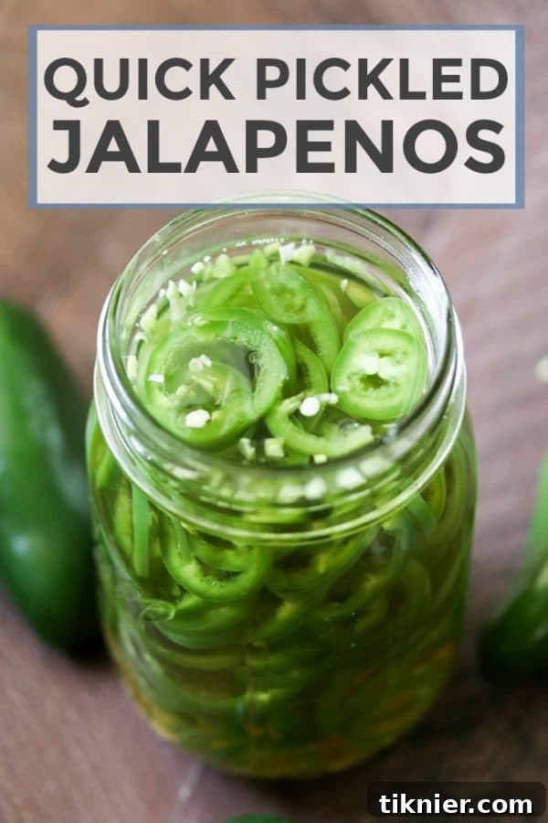 Instant Tangy Jalapeno Rounds 2 Vibrant green quick pickled jalapenos slices meticulously arranged in a clear glass jar, capturing their freshness and readiness to enhance any meal.