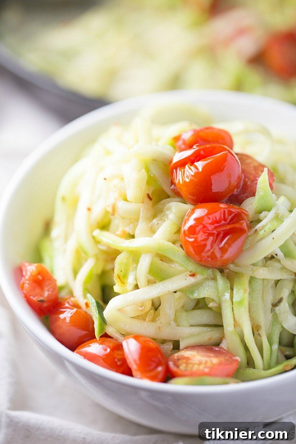 Simple and healthy Zucchini Noodles with Roasted Tomatoes in a light white wine sauce, cooked in one skillet for easy cleanup. A perfect low carb meal.