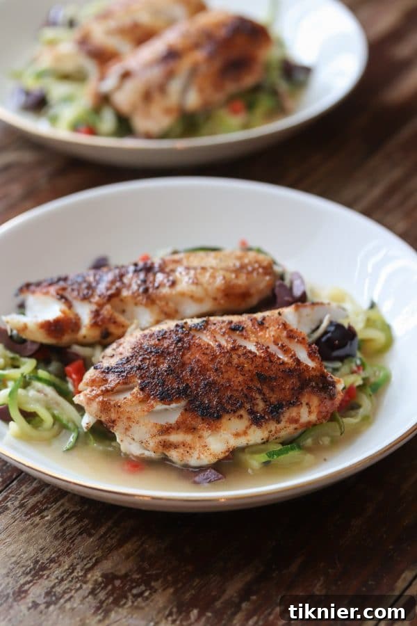 Delicious and healthy mediterranean seasoned Black Sea Bass served with grain free and low carb zucchini noodles. SO easy to make and ready to serve in under 30! #seafood #seabass #lowcarb #glutenfree #dinner #keto
