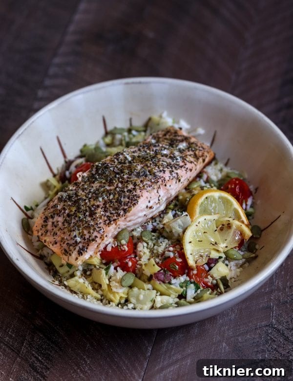 A Really Good Salmon Bowl that's full of healthy and flavorful ingredients. Featuring tender salmon, roasted tomatoes, fresh herbs, and a delicious homemade dressing. #salmon #healthy #recipe #glutenfree #healthyrecipe #dinnerbowl #quickdinner