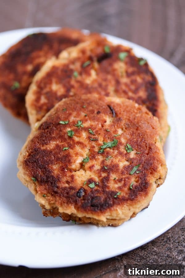 The easiest salmon cakes you'll ever make! These paleo salmon cakes are made with canned salmon, paleo mayo, spices, and almond flour! Serve them as an appetizer or with your favorite veggie for a complete healthy meal. #paleo #salmon #savory #dinner #appetizer #healthyrecipes