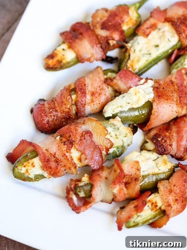 Delicious Paleo Jalapeno Poppers stuffed with almond cream cheese and mayo, wrapped in sugar-free bacon. Perfect for baking or grilling, a fantastic paleo appetizer or snack. #paleo #jalapenopoppers #bacon #appetizer #keto #healthypartyfood
