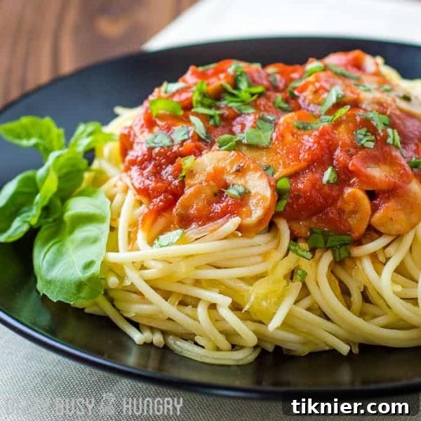 A serving of Healthier Spaghetti, featuring vegetables and spaghetti squash, a lighter take on a classic comfort food.