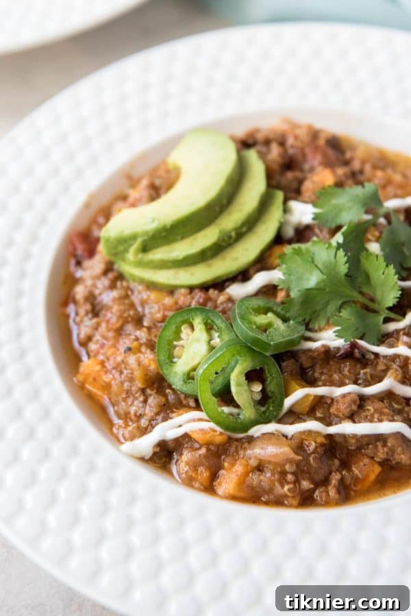 A warm bowl of Instant Pot Turkey Sweet Potato Quinoa Chili, garnished with fresh cilantro, a healthy and comforting meal.