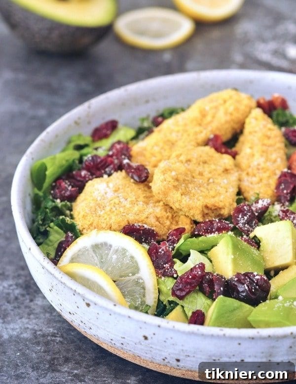 A vibrant Vegan Chicken Cranberry Salad with mixed greens, cranberries, and a creamy dressing, a healthy and soy-free meal.