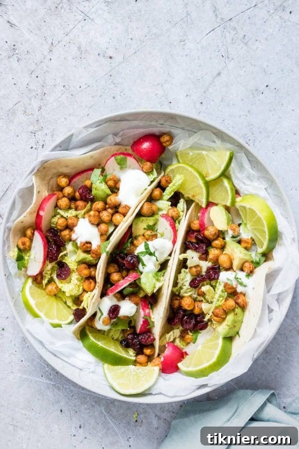 Crispy Chickpea Tacos filled with fresh vegetables, avocado, and a creamy sauce, a perfect vegetarian and air-fried dinner.