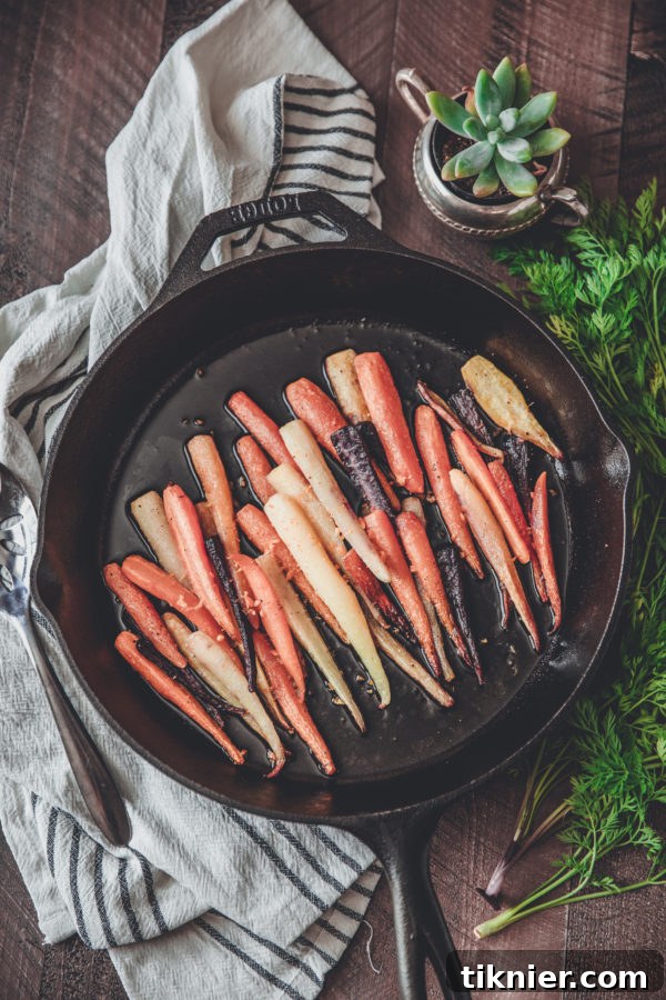 Golden Roasted Rainbow Carrots with Creamy Carrot Puree 2 Vibrant roasted rainbow carrots in a rustic wooden bowl, garnished with fresh herbs and a potted succulent.
