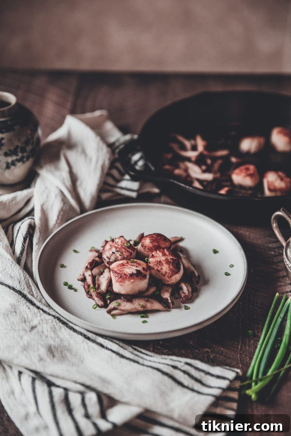 Close-up of Scallops with Bacon, Mushrooms, and Chives in a Skillet